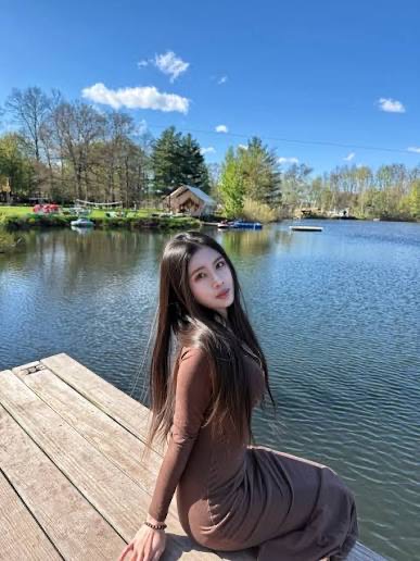 Guest sitting on the wooden dock in the sun beside the spa lake