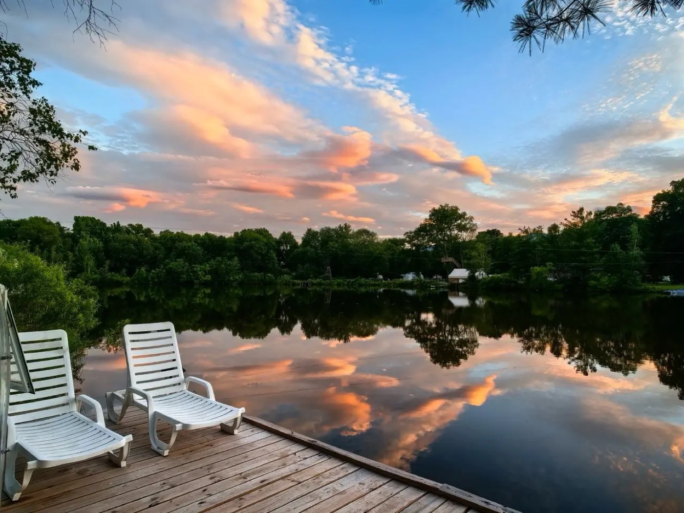 Wooden dock with loungers at sunset beside the spa lake in Catskill, New York